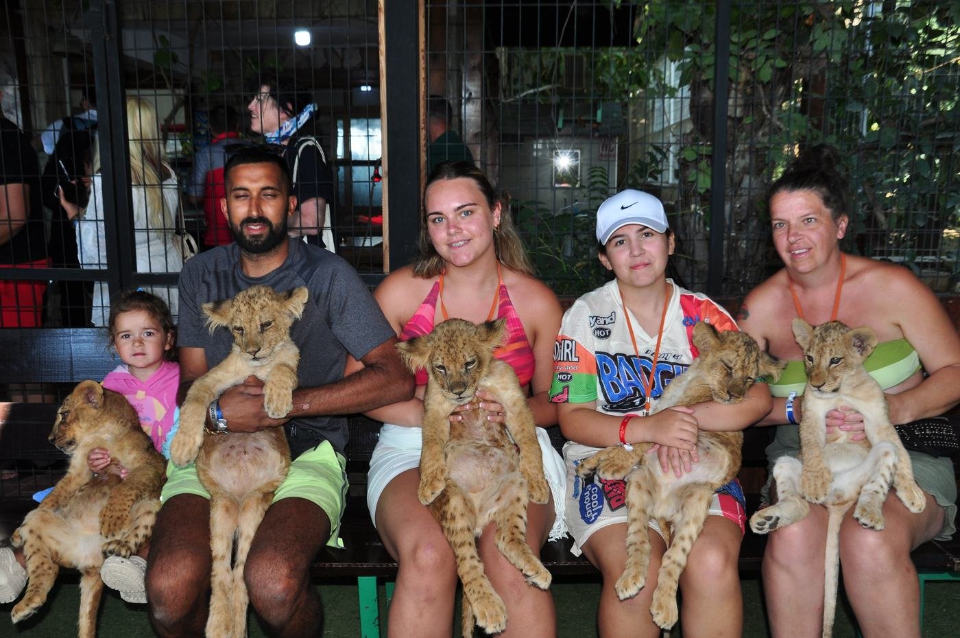 Family holding baby lions at Antalya Lions Park